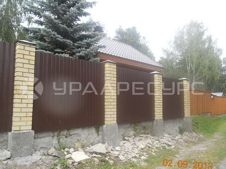 Забор из профлиста с каменными колоннами в пос. Шувакиш
